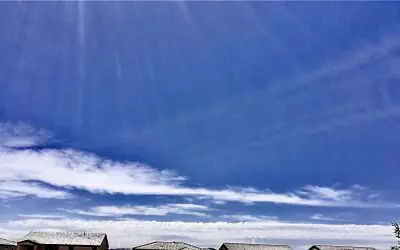 The false cloudbank just above the homes is from early morning chemical spraying.